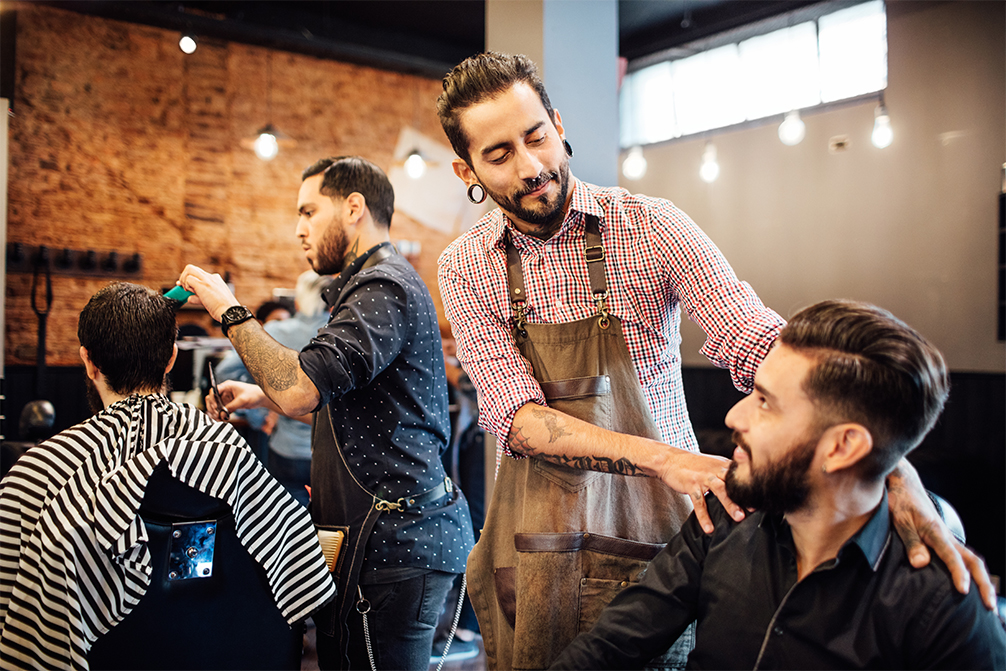 Barber looking at customer after haircut