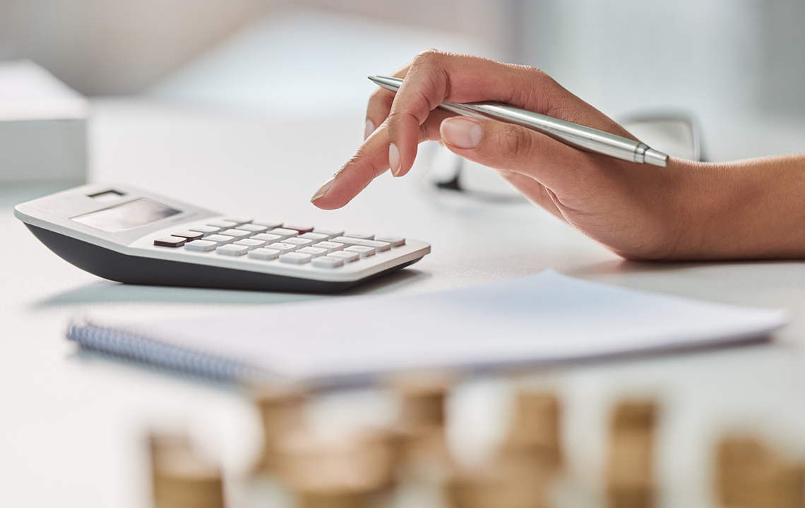 Image displaying a hand calculating a budget