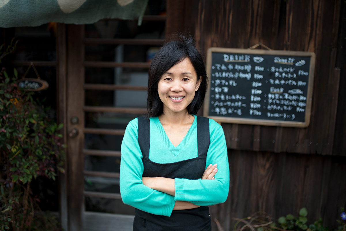 A businessperson in front of their business