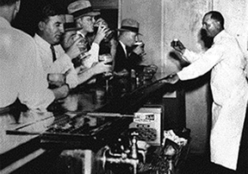 A speakeasy with a bartender serving illegal drinks to happy patrons