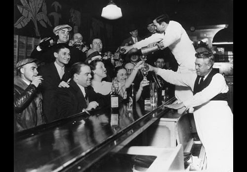 Crowd of people rushing to get a drink from a bartender after Prohibition ended