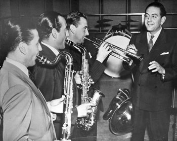 Guy Lombardo and his band, the Royal Canadians. All of the musicians are holding instruments except Guy Lombardo, who is conducting.