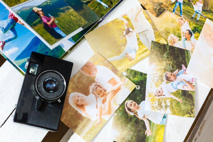 A hand held camera and a variety of different photos.