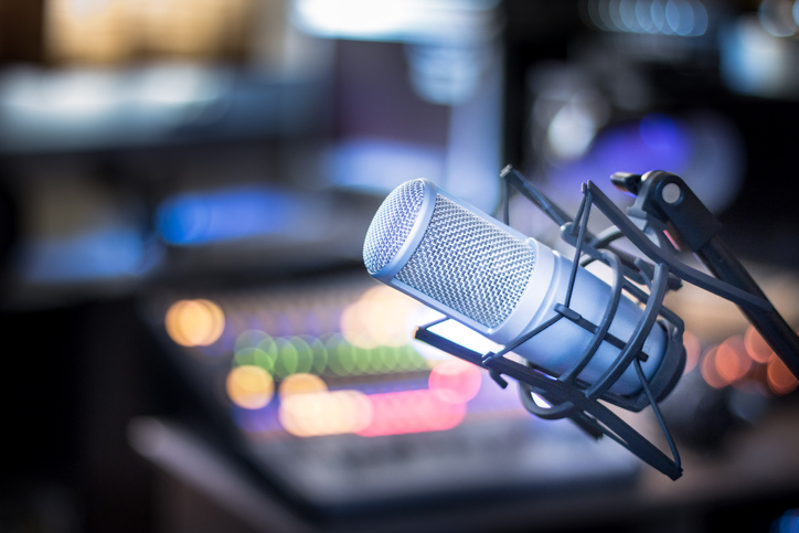 A microphone with a background of a studio.