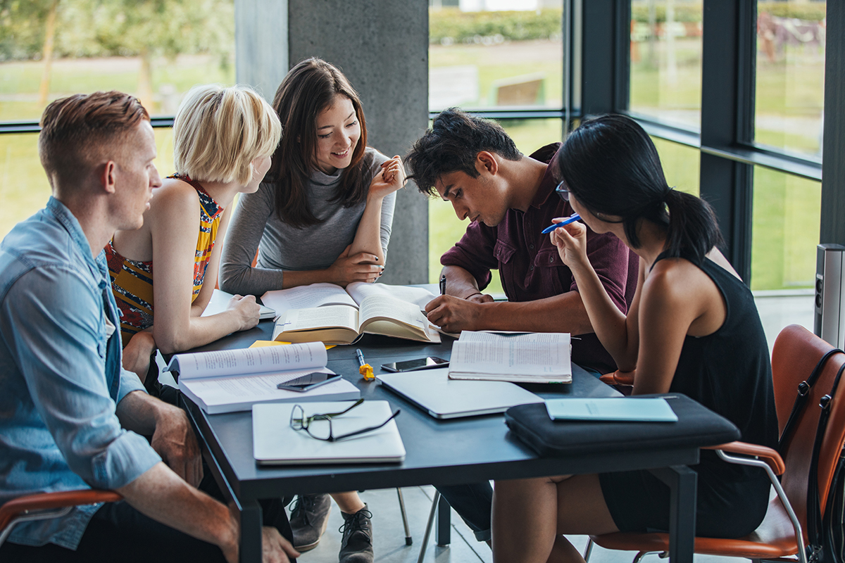 A group of students studying around the table.