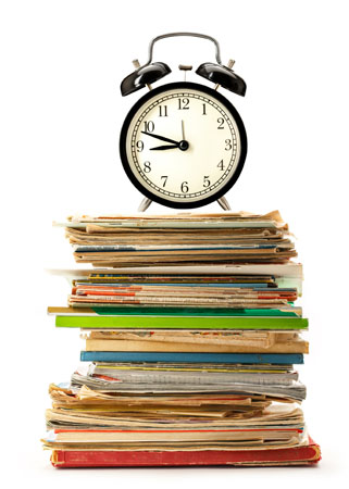 An alarm clock on a pile of books.