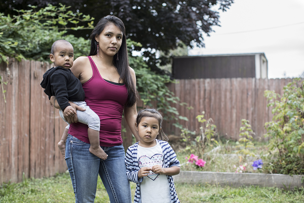 Parent with a baby and a toddler