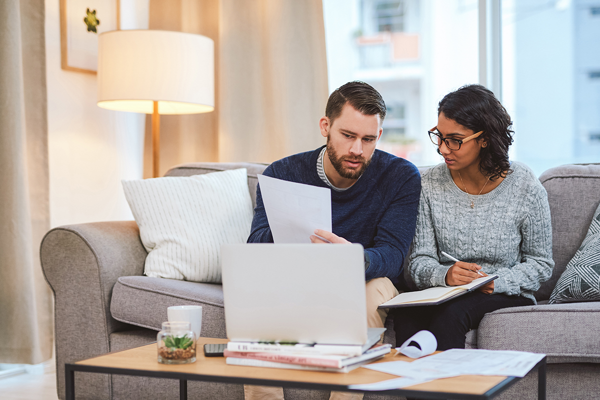 Couple sitting in front of the computer, discussing finances