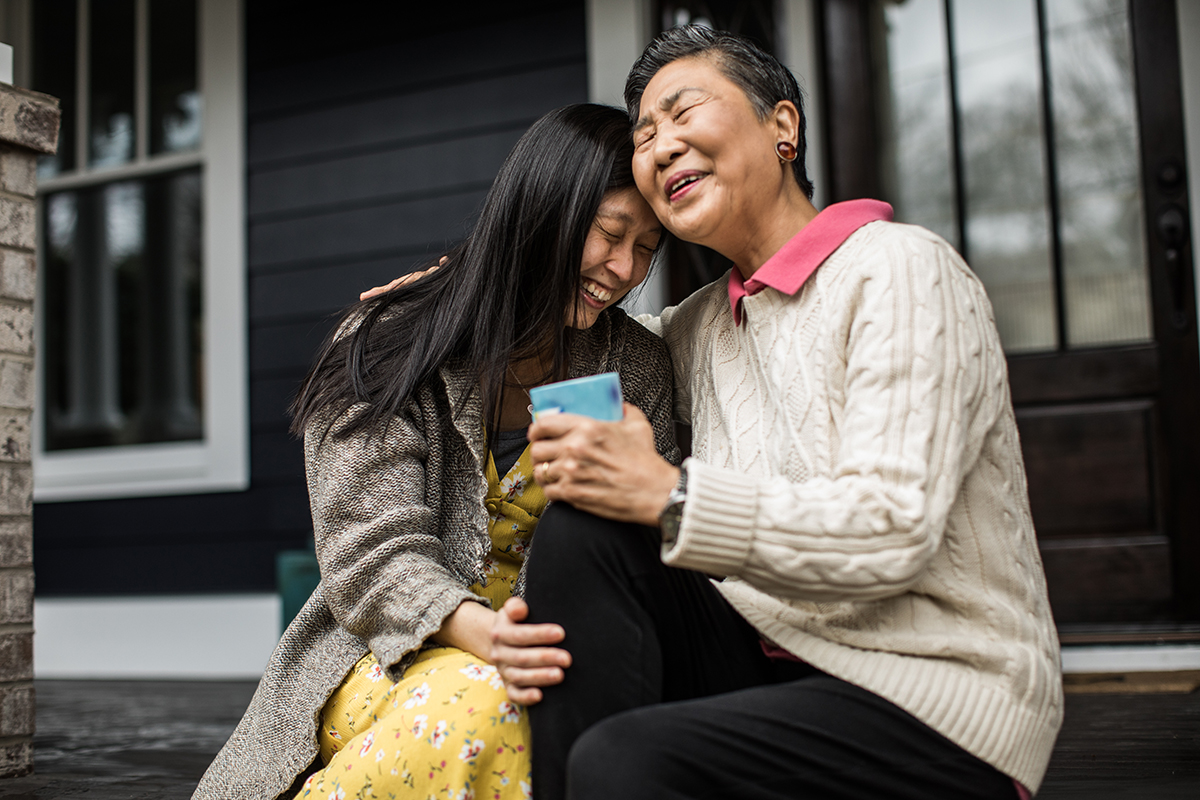 Parent hugging their child on the front porch