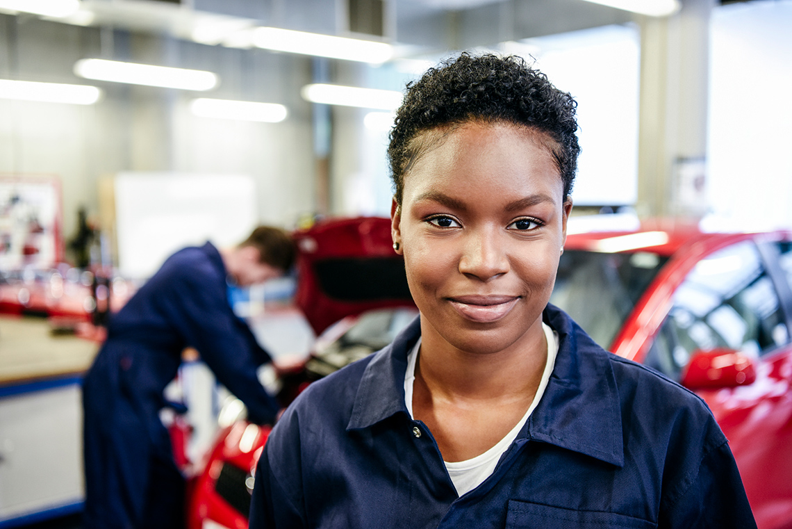 An individual working at an automobile shop