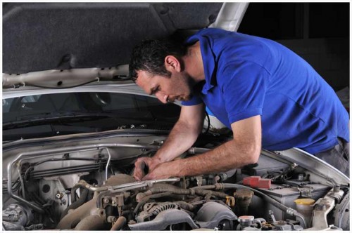 A person working on the engine of a car