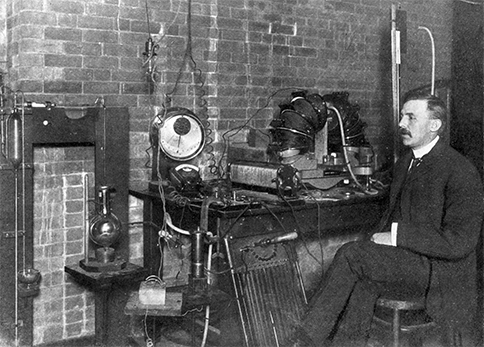 Ernest Rutherford with the experimental set-up used to determine an atom’s structure.
