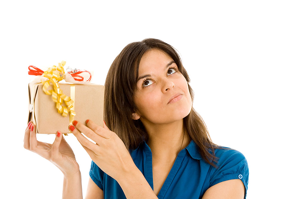 A person holding box, trying to guess what is in the box.