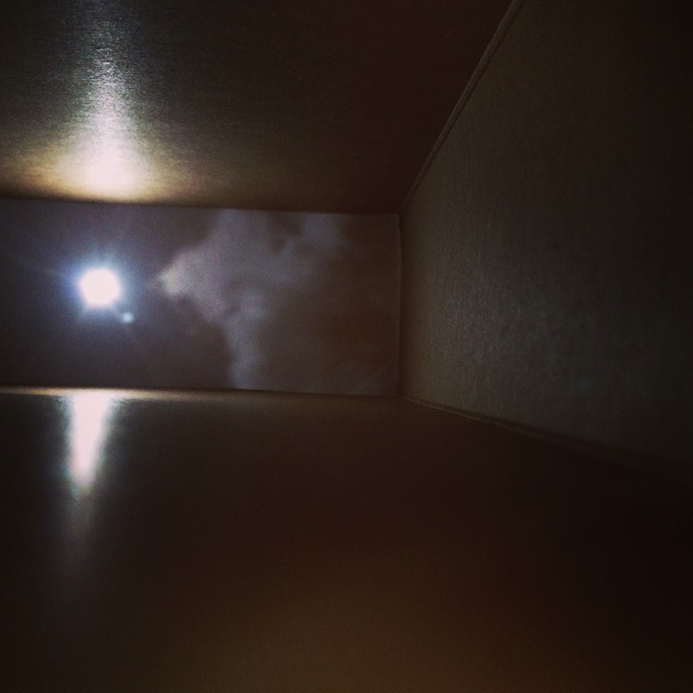 Sun and clouds projected on to the inner surface of a cereal box.