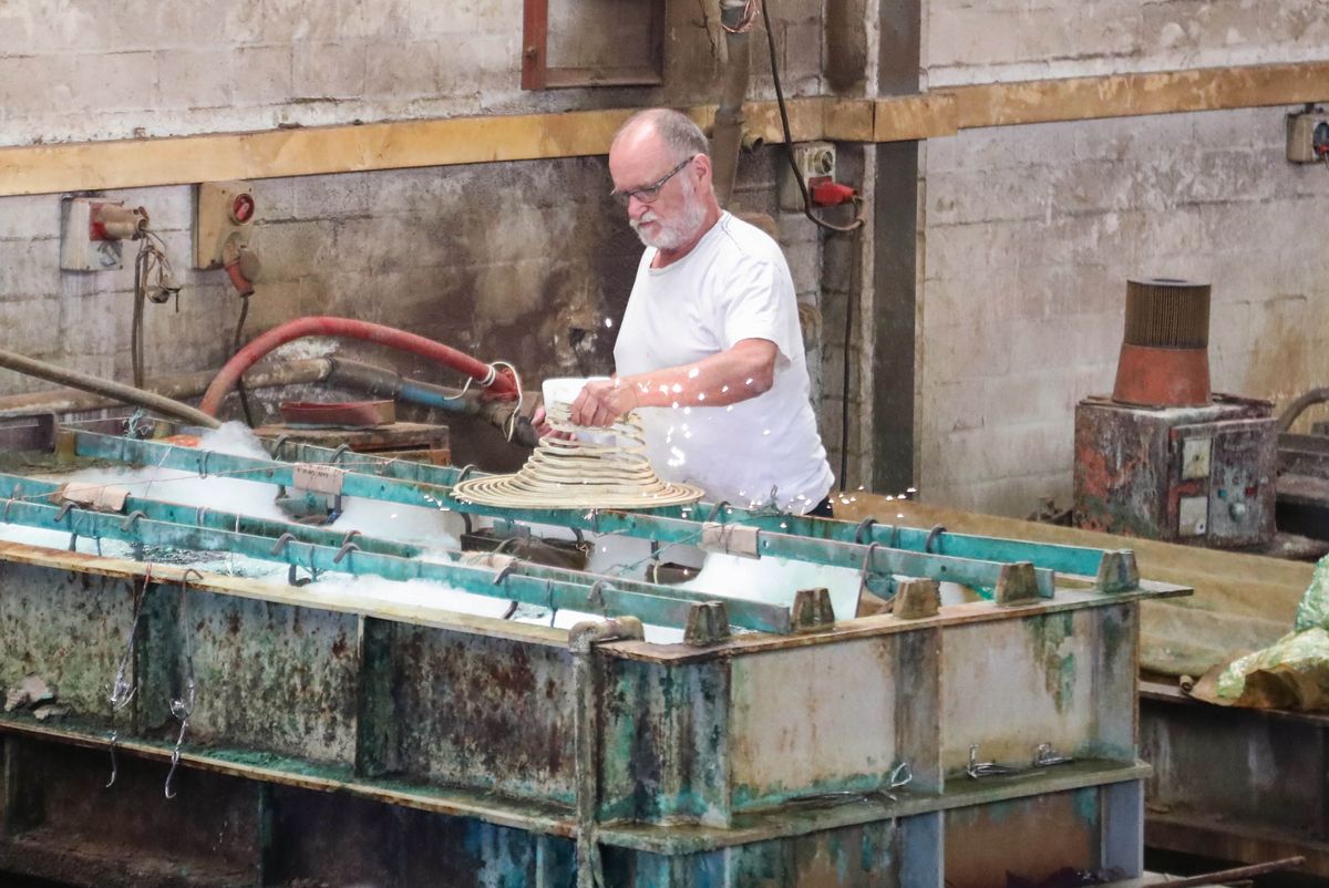 A Senior artist electroplating his artwork